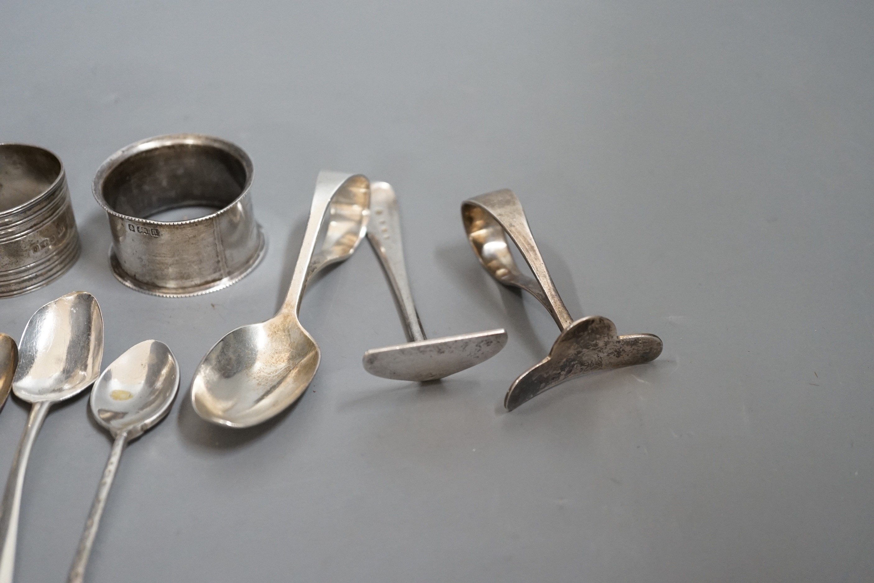 A miscellaneous collection of small silver items to include napkin rings, spoons, etc.